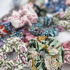 Assorted block-print cotton hair scrunchies in vibrant patterns