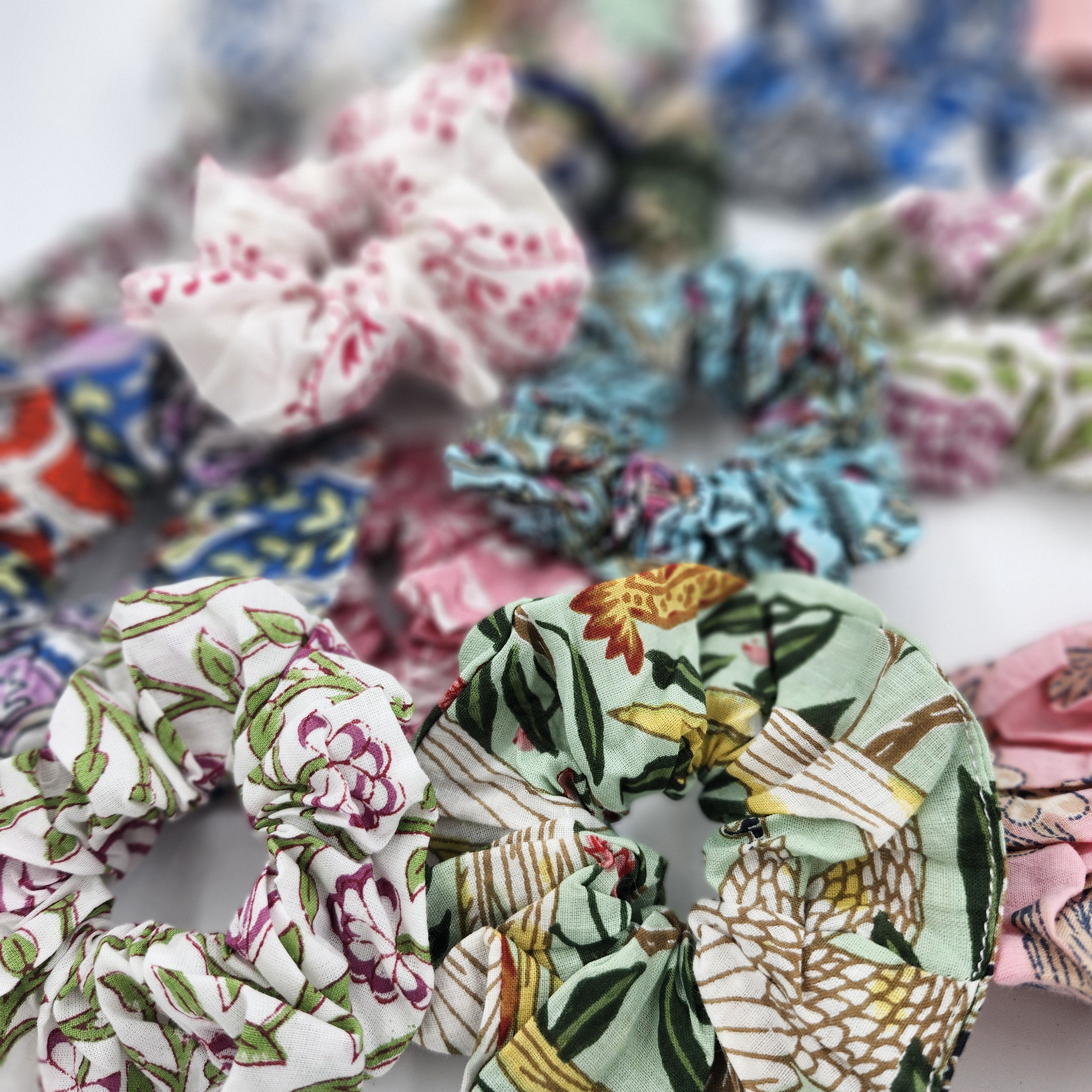 Assorted block-print cotton hair scrunchies in vibrant patterns