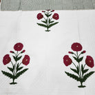 Hand quilted block print bedspread with detailed poppies on a creamy white ground, 100 per cent cotton.