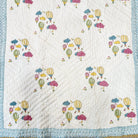 Child's block-print cotton quilt with a colourful balloon pattern, machine washable, 102 x 152 cm