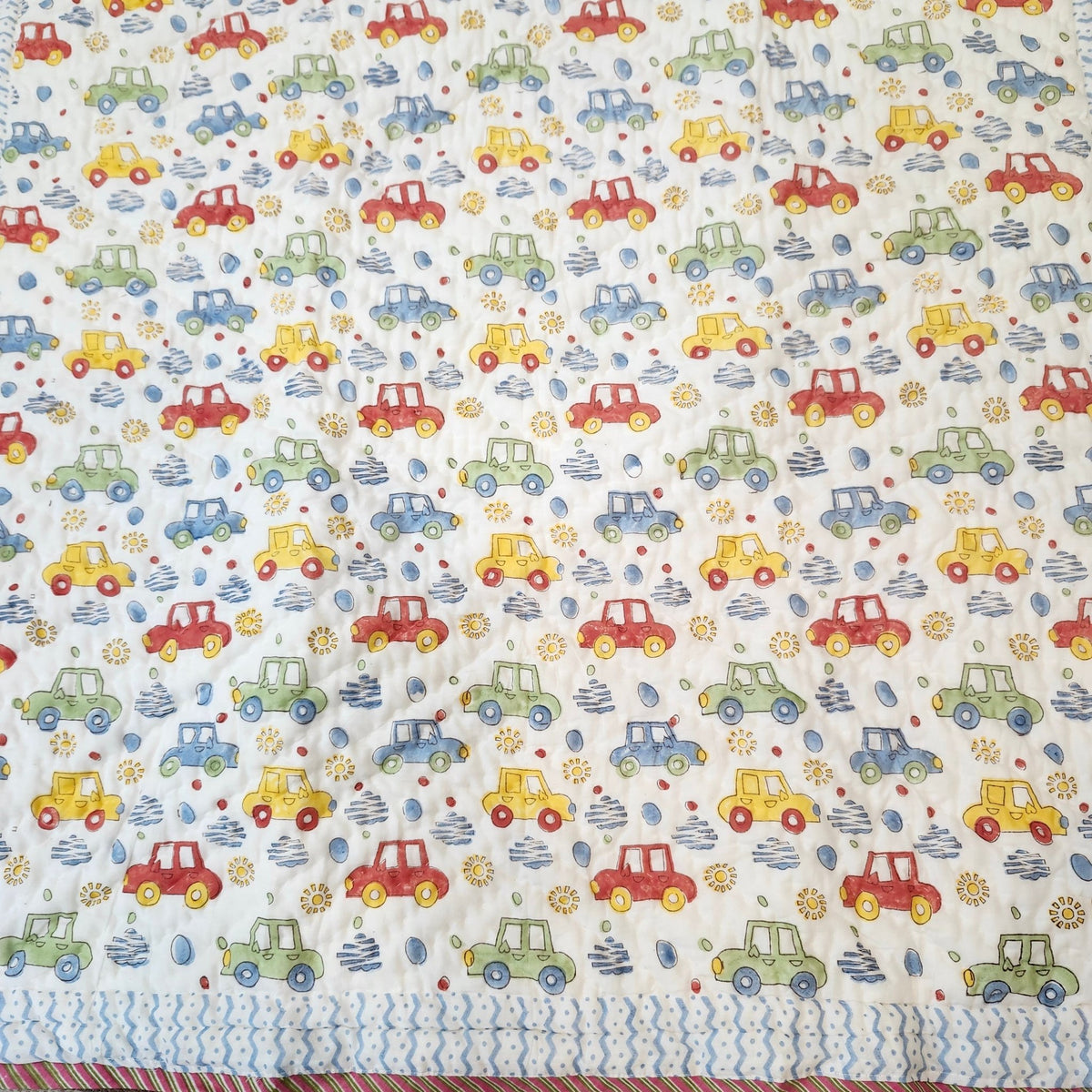 Colourful car block-print cotton quilt for children, suitable from age three, detail of the print