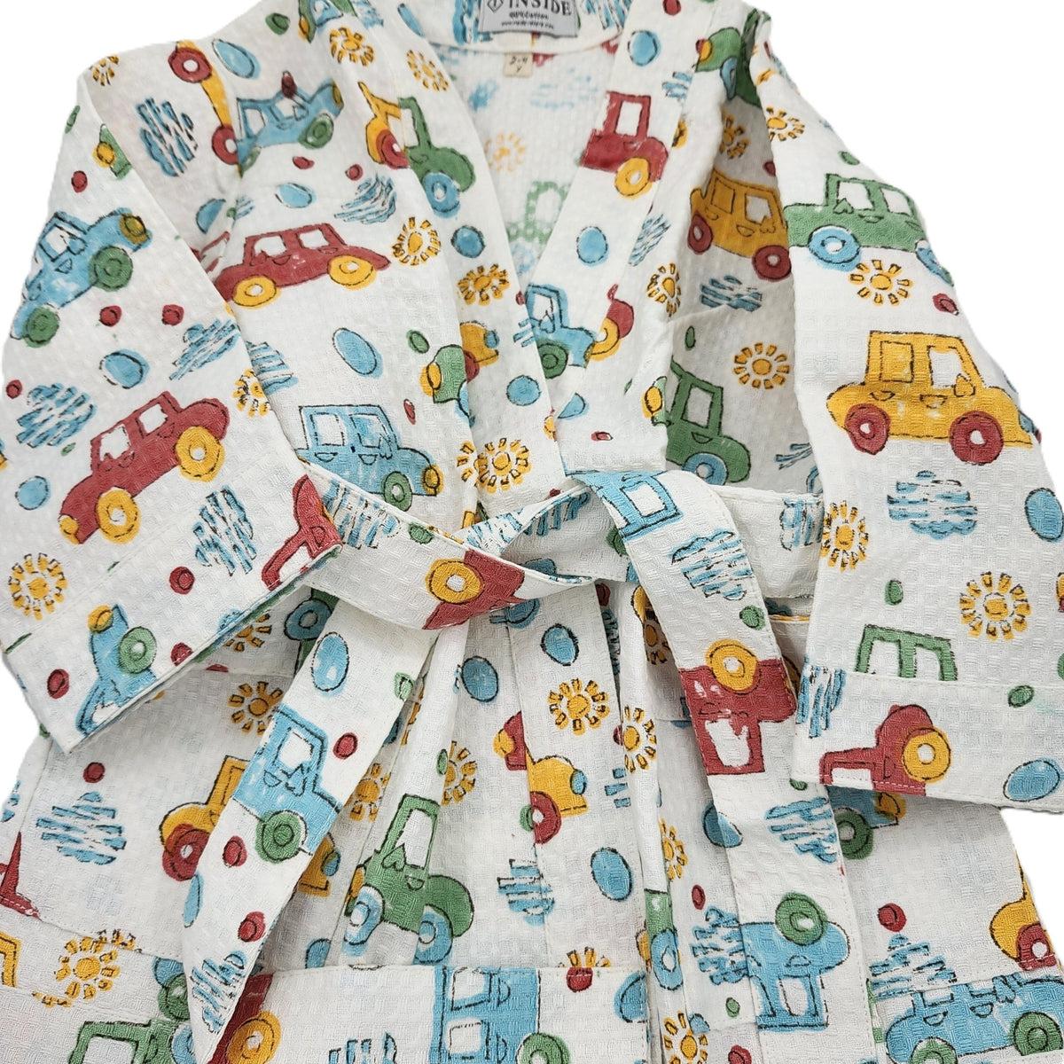 Car print child's waffle bath robe with a matching belt and two handy pockets, quick drying, made with non-chemical dyes
