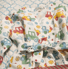 Child's car print waffle bath robe shown with the matching child's block print quilt, cars in red, blue, green and yellow