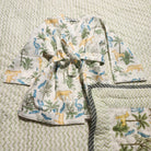 Child's jungle print waffle bath robe shown with the matching child's block print quilt in the same design of cats and birds