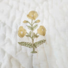Yellow marigold child's quilt, reverse with a smaller marigold print