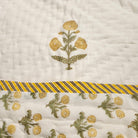 Reverse of the marigold child's quilt, a smaller marigold print, reversible and machine washable, suitable from age three