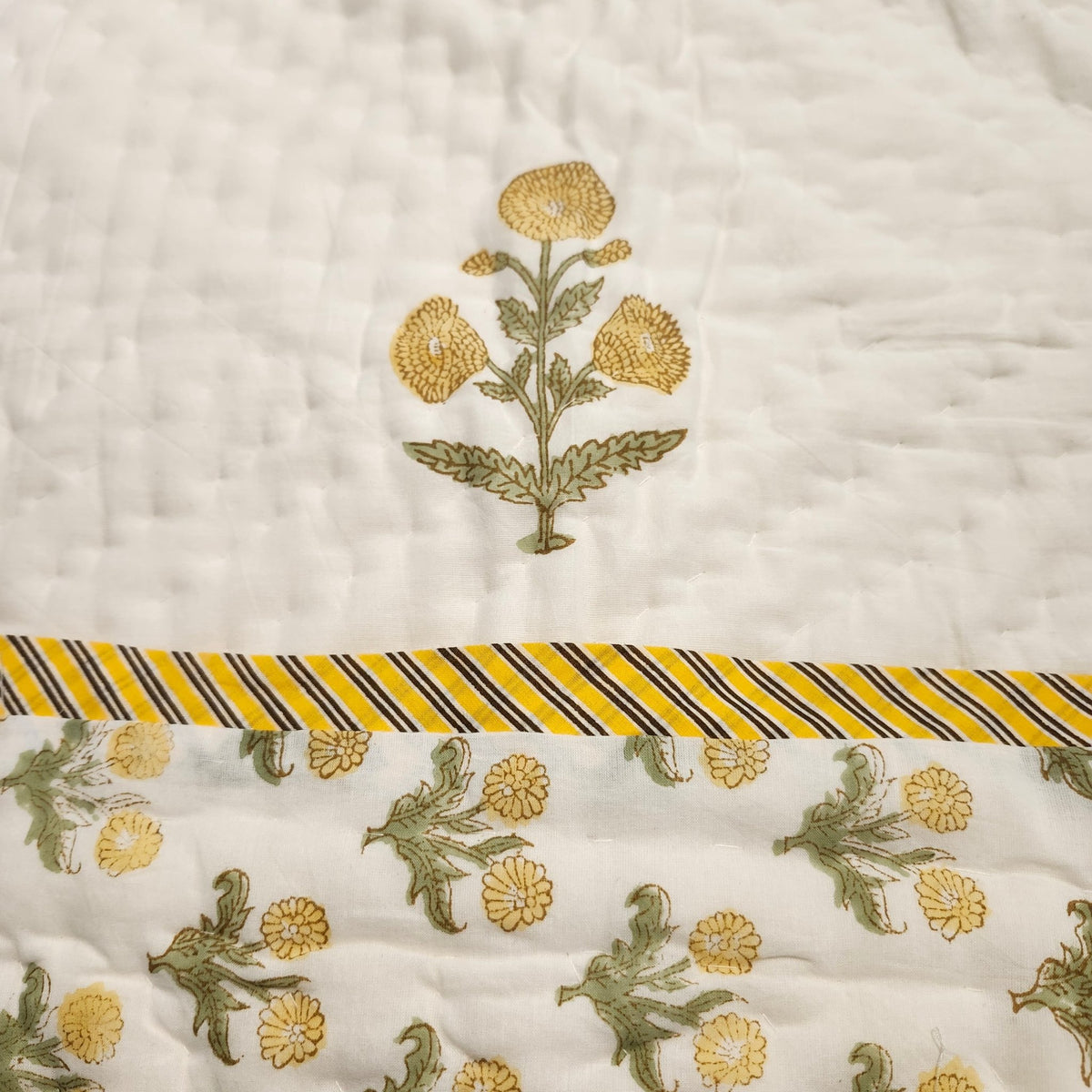 Reverse of the marigold child's quilt, a smaller marigold print, reversible and machine washable, suitable from age three