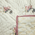 Detail of the mermaid child's quilt, with a contrast pattern in yellow on the reverse, reversible and machine washable warm