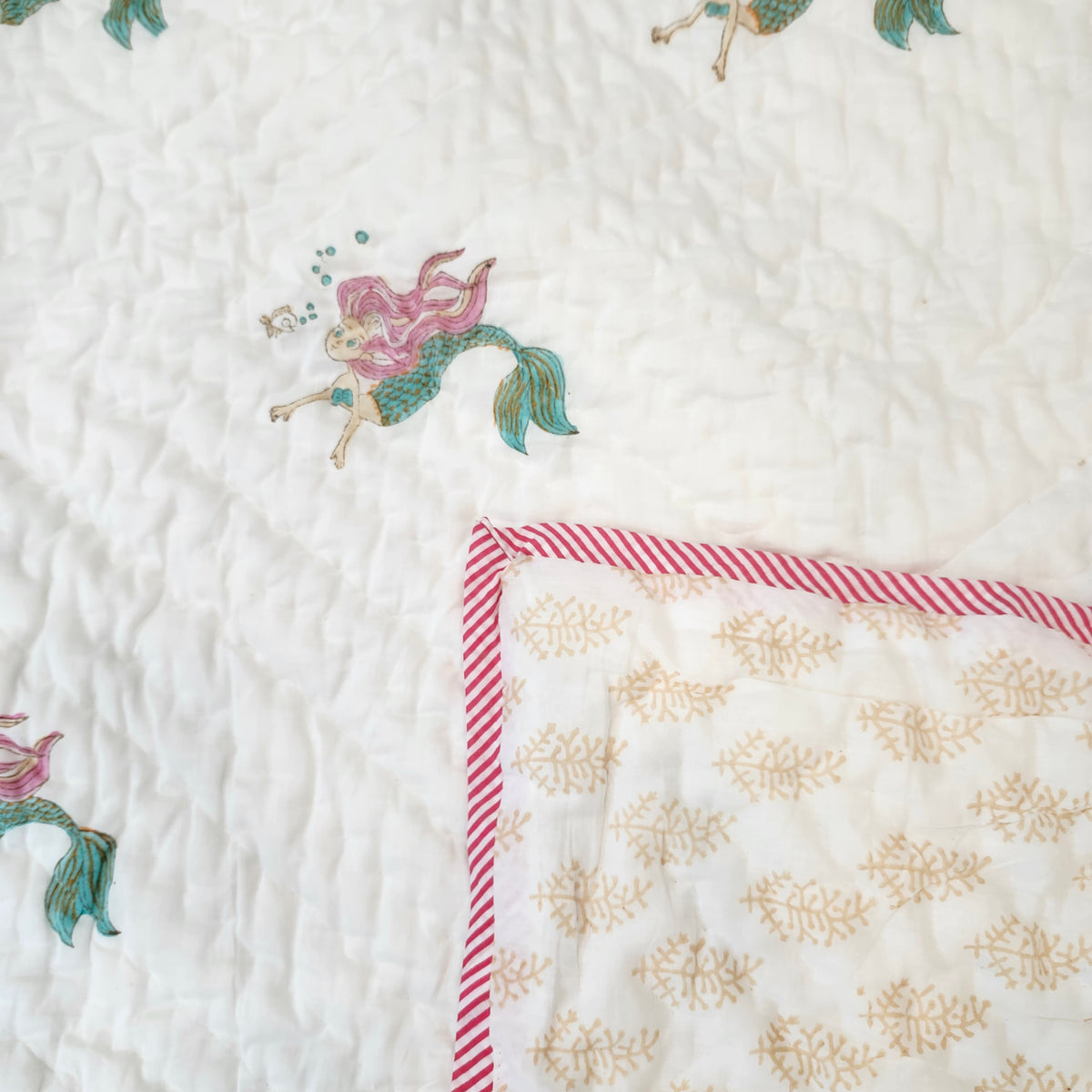 Mermaid block-print cotton quilt for children, suitable from age three, close detail of the print