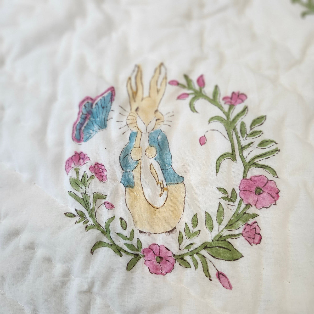 Child's block-print organic cotton quilt with an adorable Peter Rabbit print, machine washable