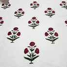 The king size poppy bedspread styled on a bed, 260 by 260cm, hand block printed and hand quilted.