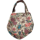 Styled view of the block print bag, which has a contrast lining and an internal zippered pocket.