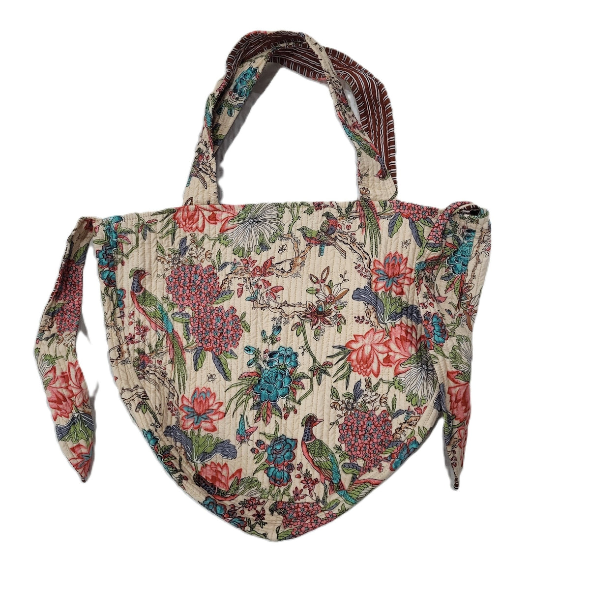 The block print bag shown with its side ties tucked in, revealing the contrast block print lining.