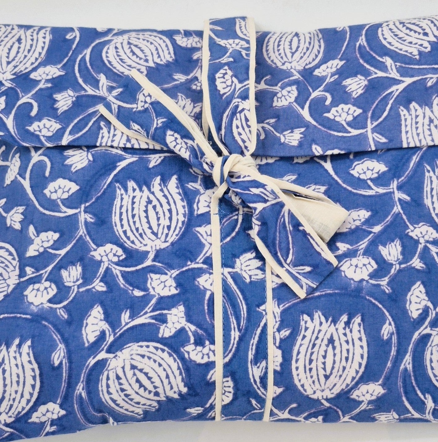 A blue lotus envelope bag, containing a pair of matching pyjamas