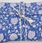 A blue lotus envelope bag, containing a pair of matching pyjamas