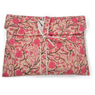 Assorted floral long pyjamas shown with their matching envelope bag, tied with a ribbon for gifting.