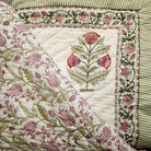 Single block-print quilt with pink tulips on white