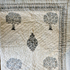 Single block-print quilt with a mango tree print and blue striped border