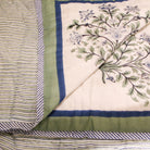 Reversible block-print quilt with blue flowers and lime stripes