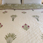 Queen block-print quilt with traveller's palms in green and pink on cream