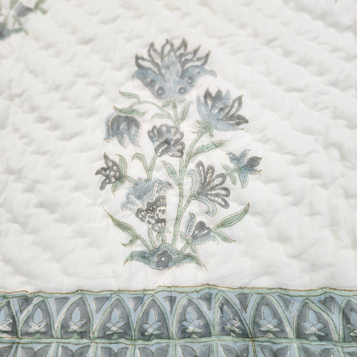 Single block-print quilt with a soft blue dahlia pattern, reversible cotton