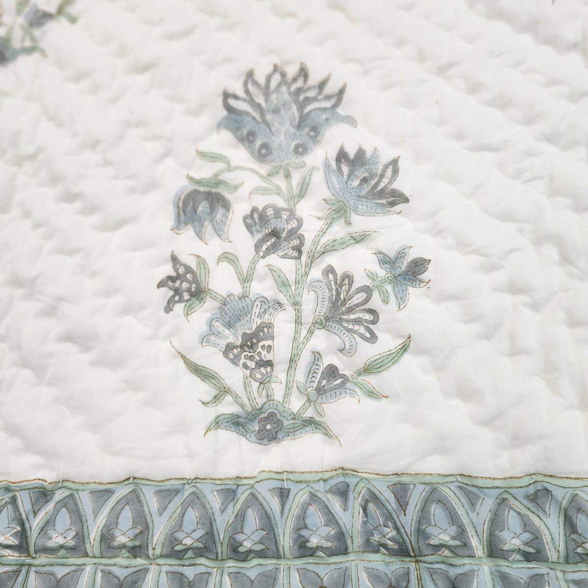 Single block-print quilt with a soft blue dahlia pattern, reversible cotton