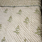 Block-print quilt, stems and leaves reverse in yellow tones