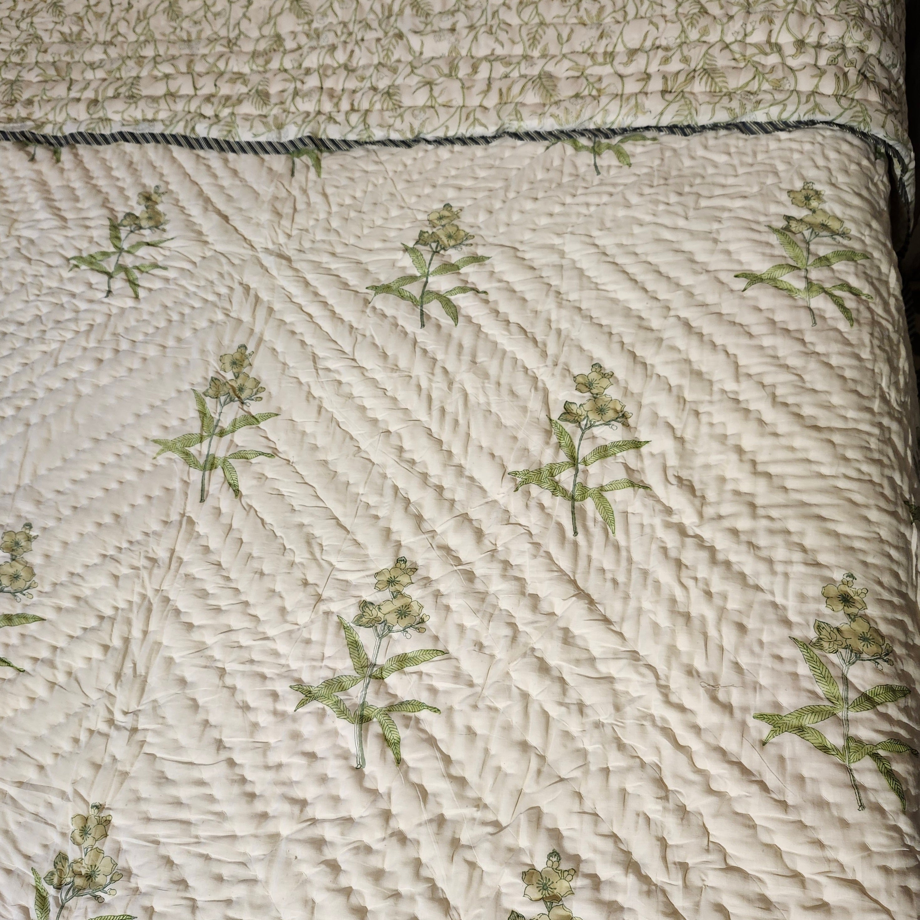 Block-print quilt, stems and leaves reverse in yellow tones