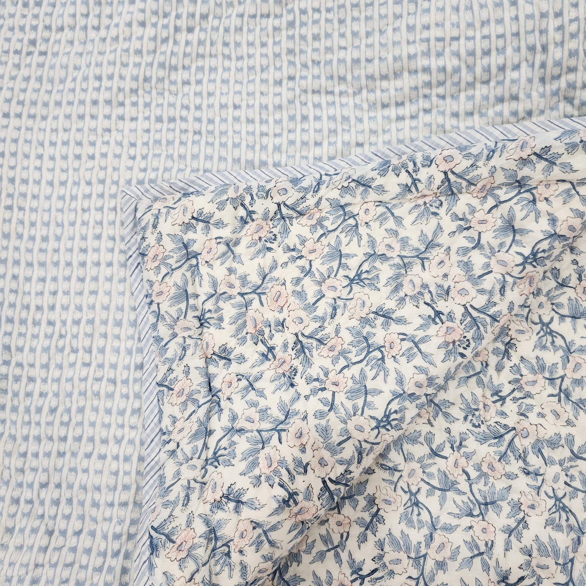 Single block-print quilt with a blue and white stripe on one side, reversible