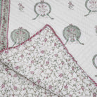Reversible single block-print cotton quilt with a repeating two-peacock motif, made in India
