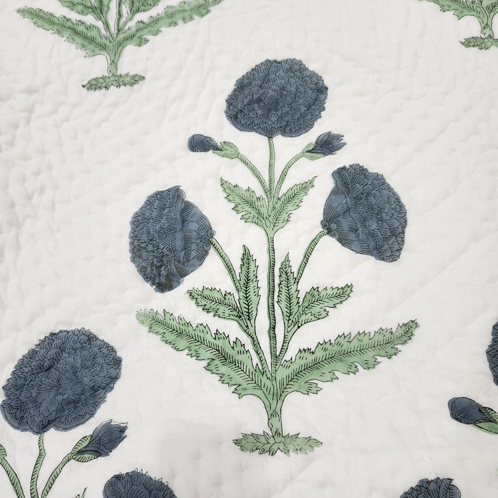 Single block-print cotton quilt with large blue poppies on one side, reversible, made in India