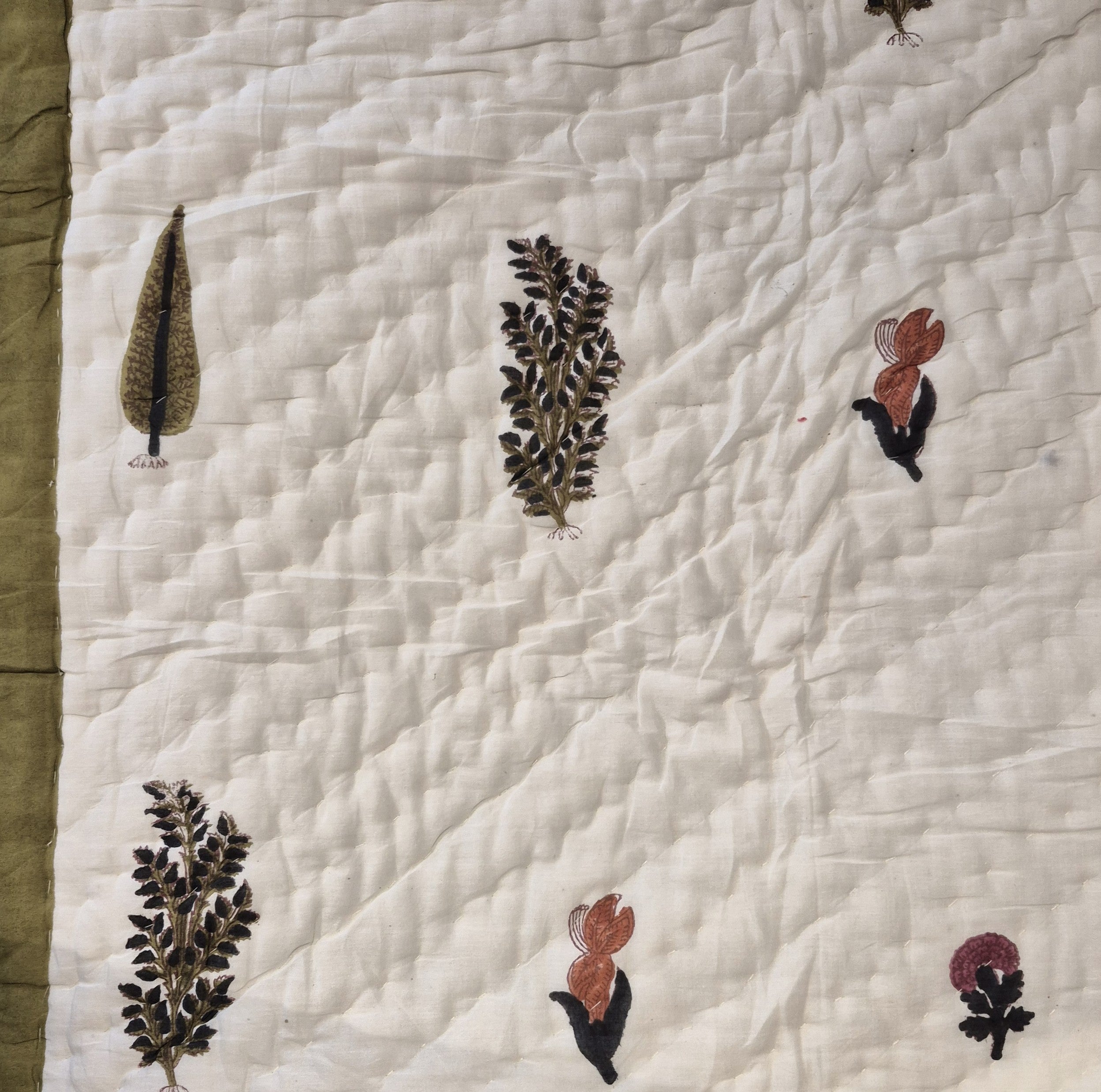 Single block-print quilt with cypress trees in olive