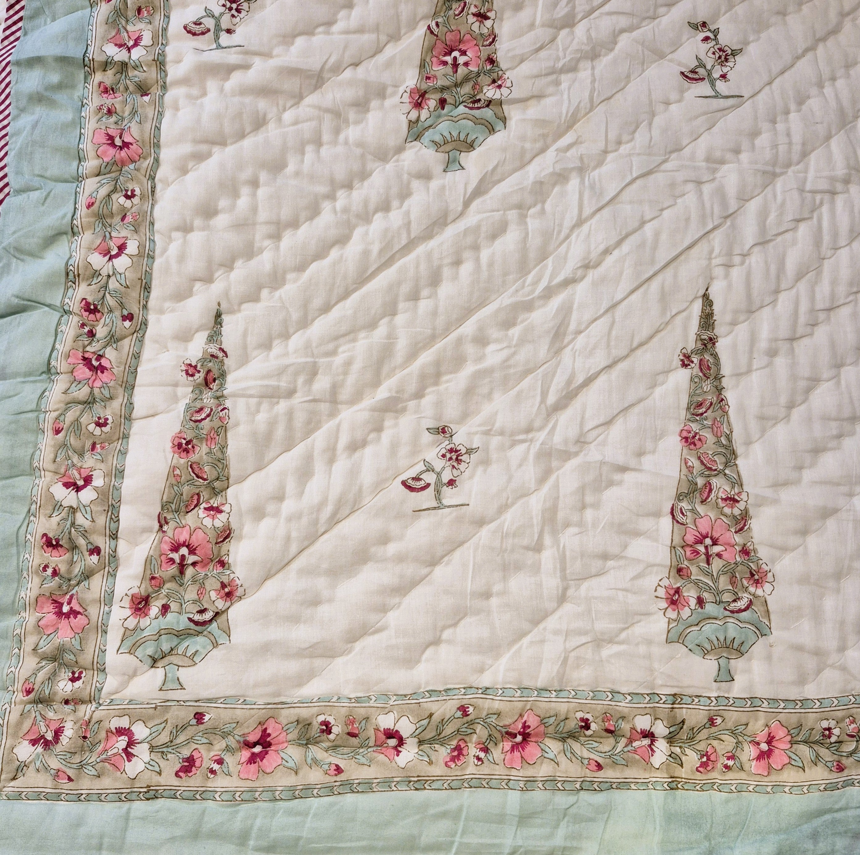 Single block-print quilt with cypress trees in pastel shades
