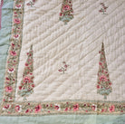 Single block-print quilt with cypress trees in pastel shades