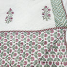 Floral reverse of the cream and pink block-print quilt