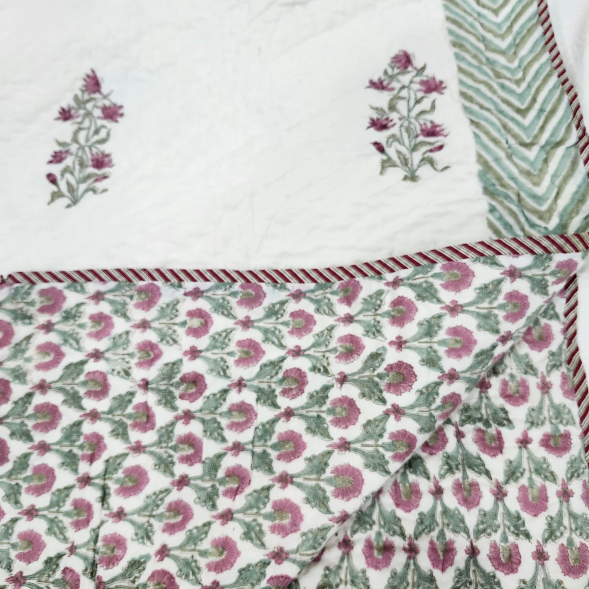 Floral reverse of the cream and pink block-print quilt