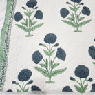 Large blue poppy block-print quilt in cotton, single size, styled on a bed