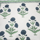 Blue poppy block-print single quilt with a blue and yellow floral print on the reverse