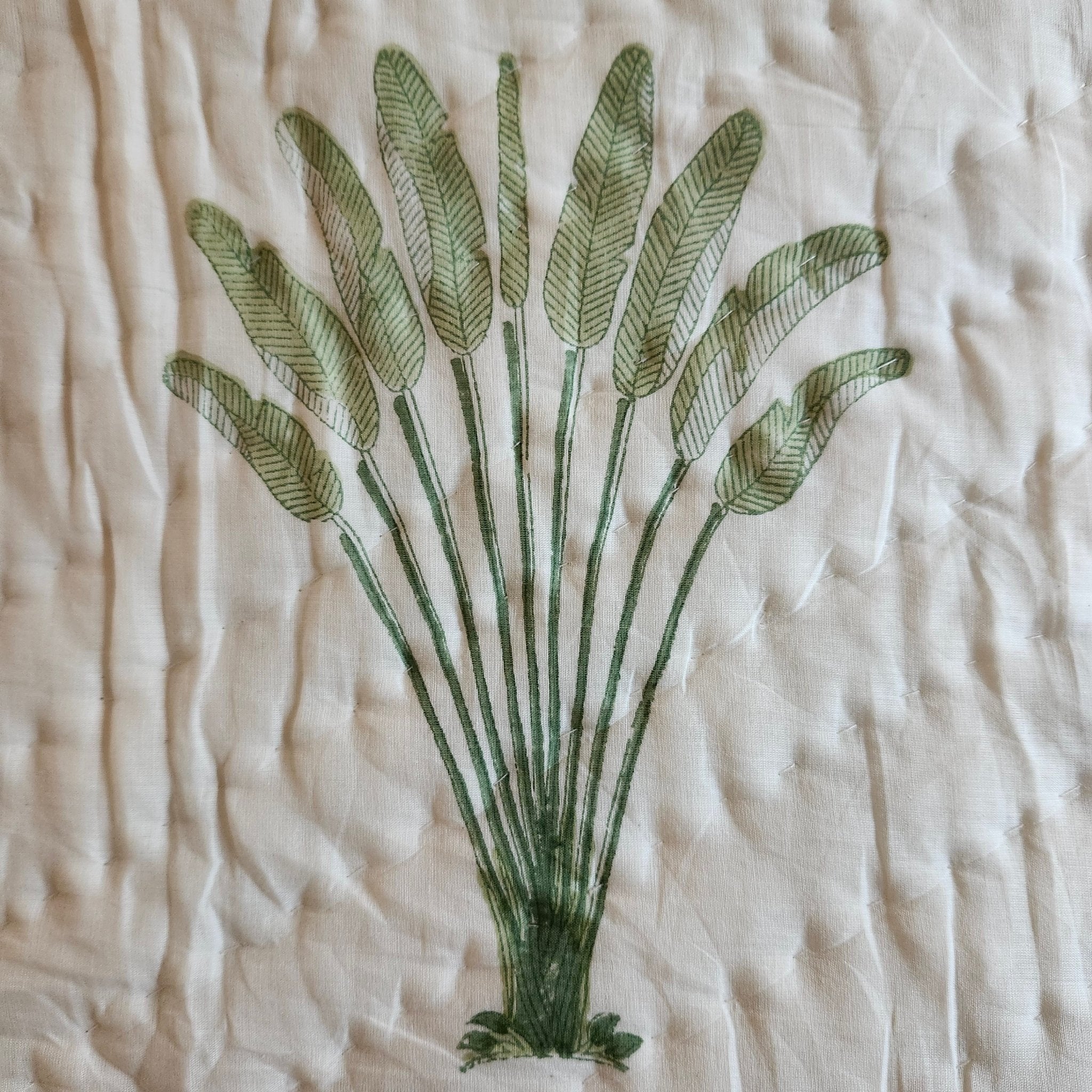 Traveller's palm block-print quilt, green floral reverse