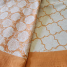 Round 225cm block print table cloth in orange/coral on white background