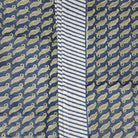 Sage green leaf block-print cotton tablecloth on blue with a striped border