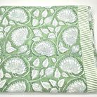 Green block print tablecloth with white lotus pattern and striped edge