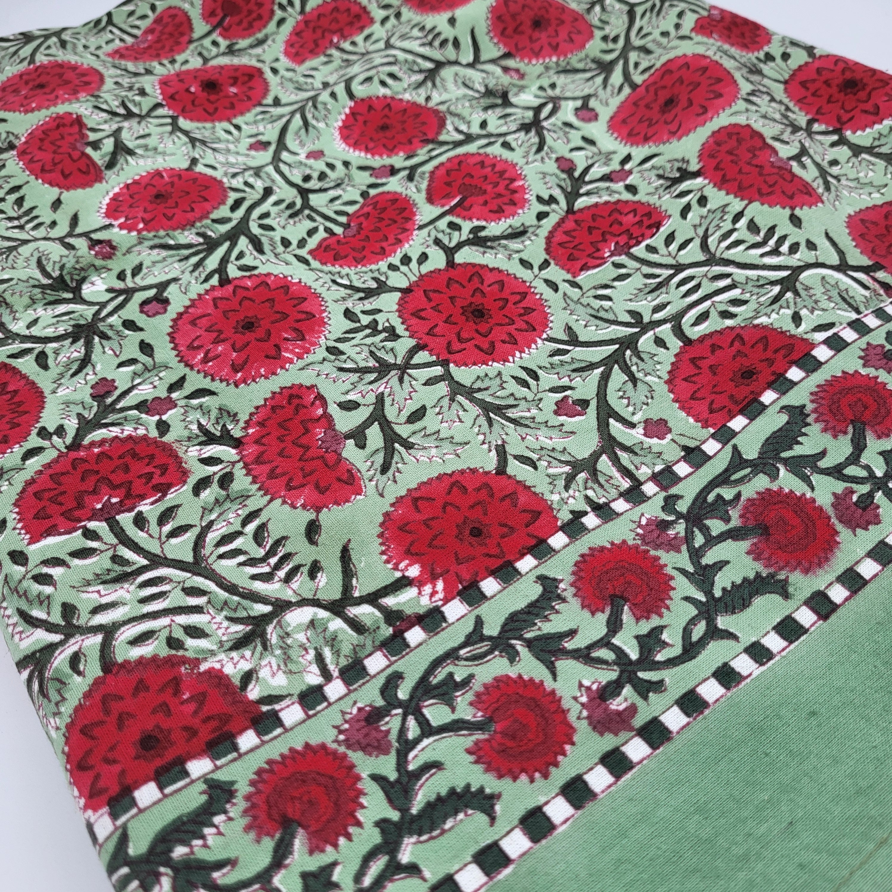 Block Print Tablecloth with red poppy pattern on a green background