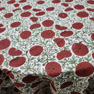 Round block-print cotton tablecloth in a green and red poppy pattern