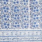 Blue and white daisy block-print cotton tablecloth with a contrast border