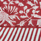 Festive red block-print cotton tablecloth with white flowers and foliage