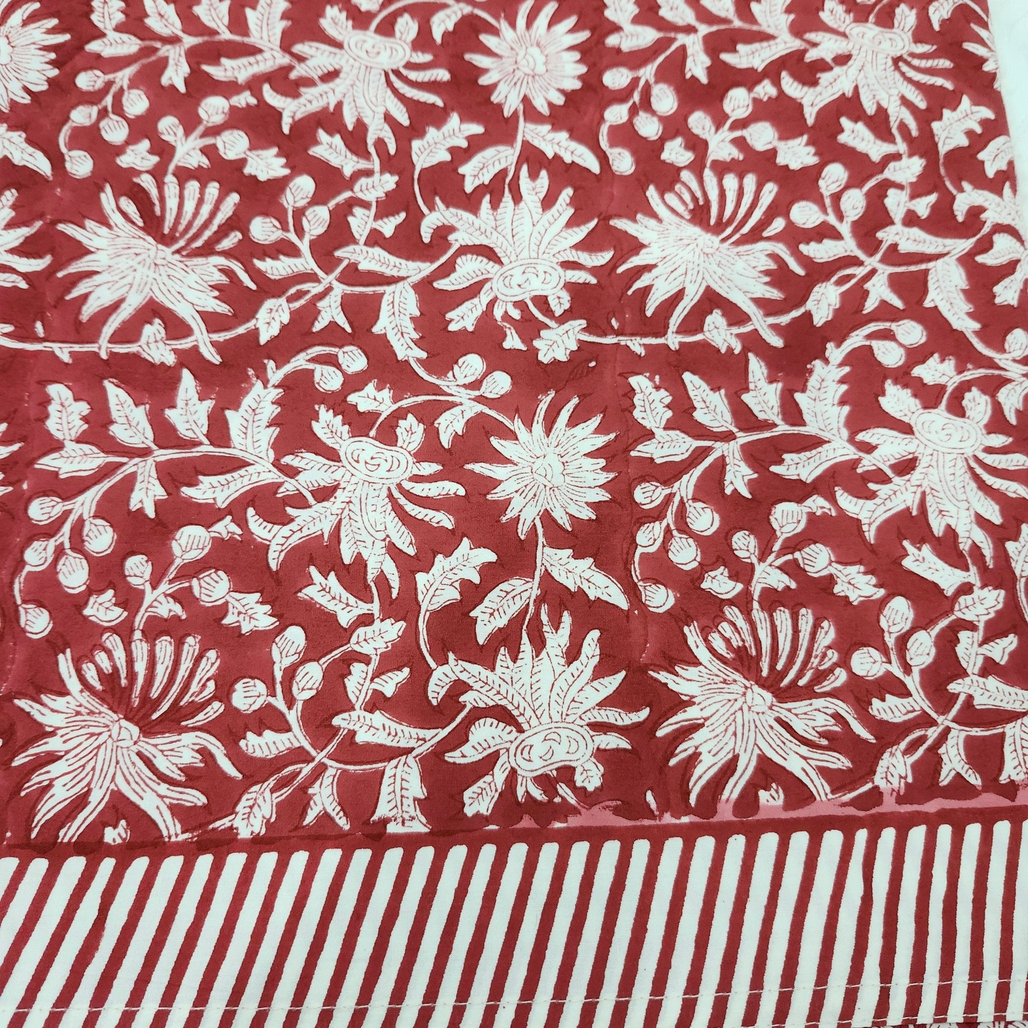 Deep red block-print tablecloth with a striped border