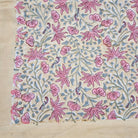 Floral block print table cloth with pink  flowers and little birds on a mustard background