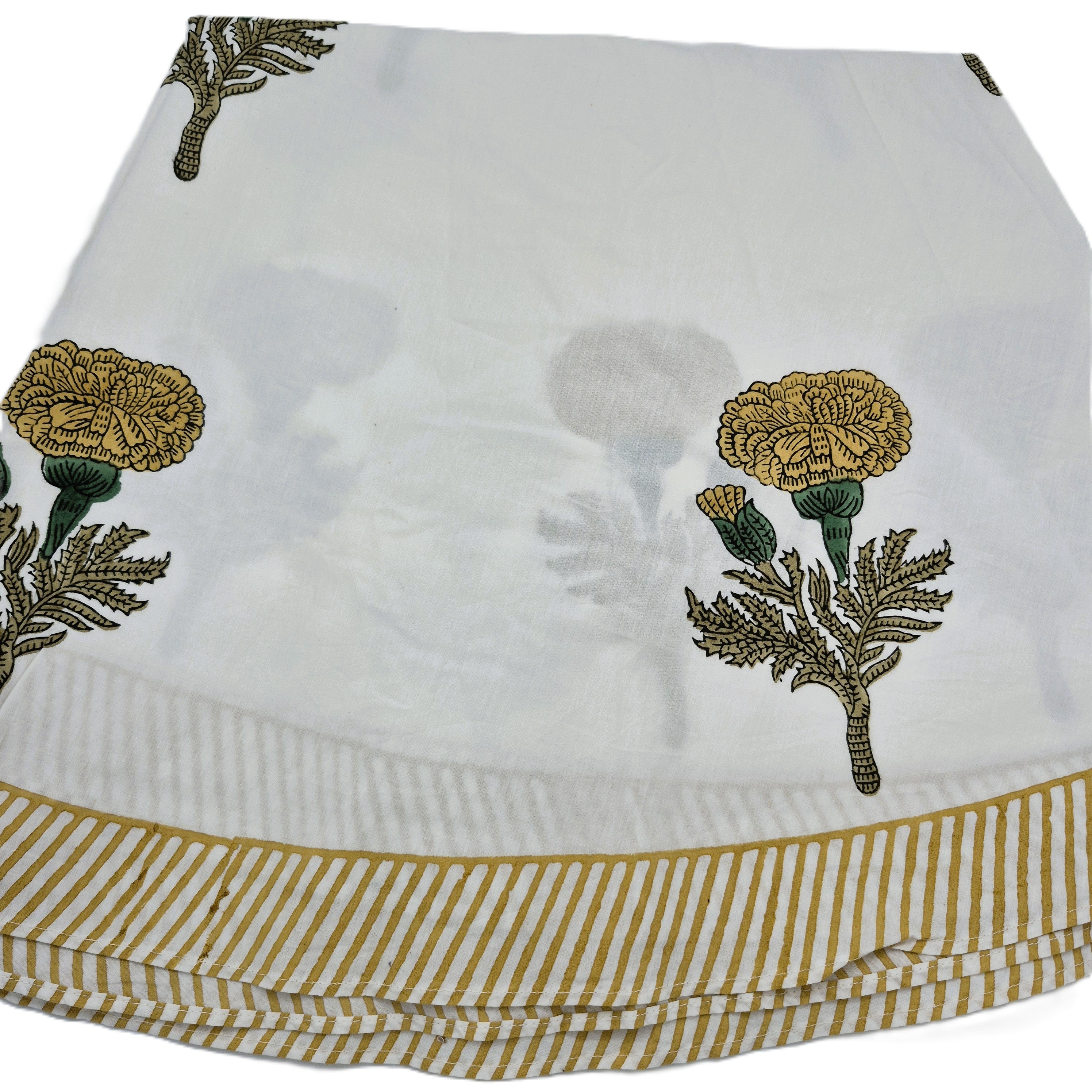A round block printed poppy tablecloth with mustard yellow flowers and striped border