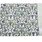 Block print tablecloth with violet flowers and green leaves on a white background
